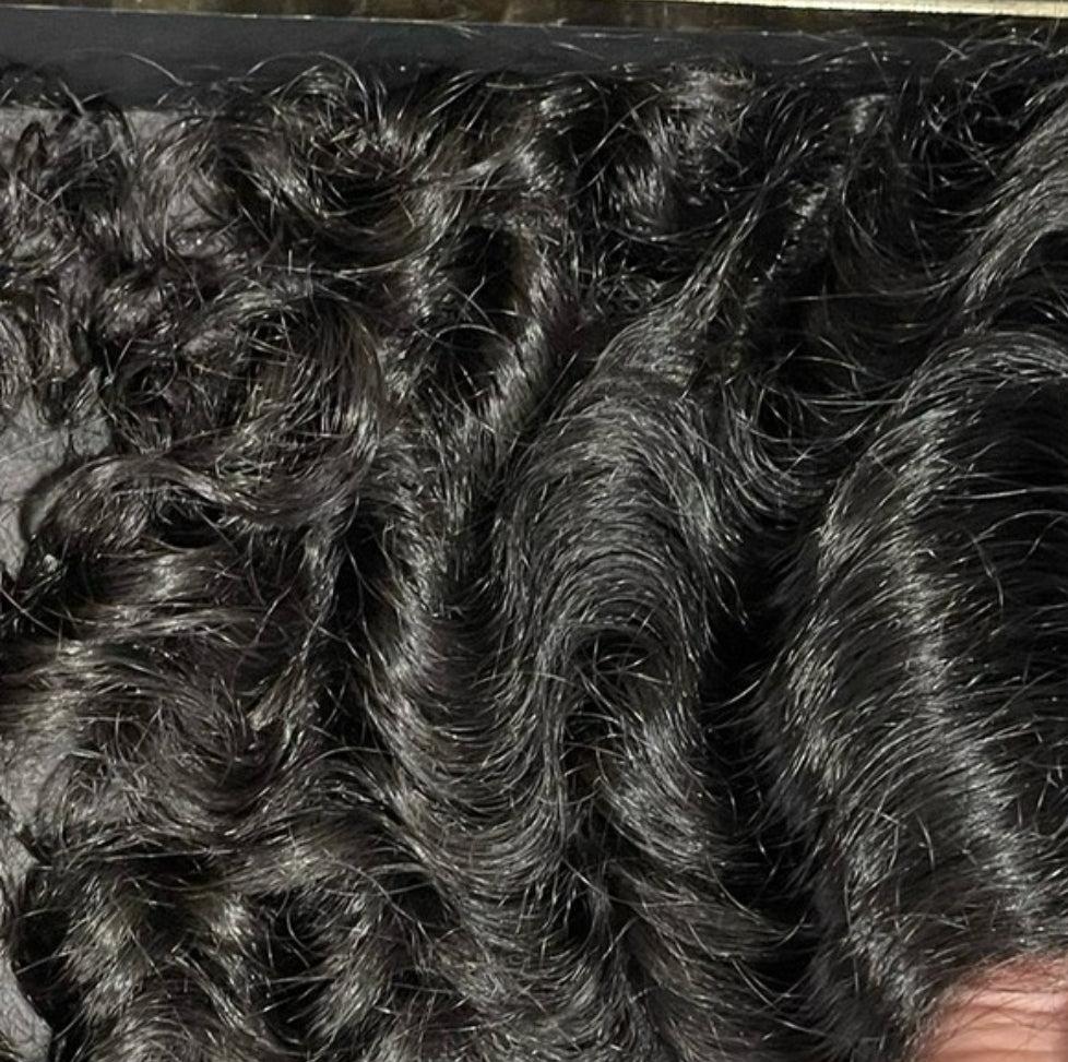 Close up of SOH Loose Curl Hair Extensions, showcasing, natural texture, and shine. 